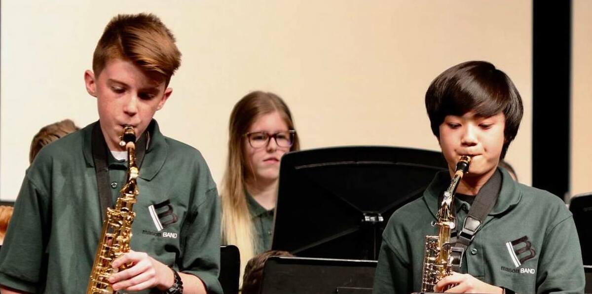 three kids playing instruments